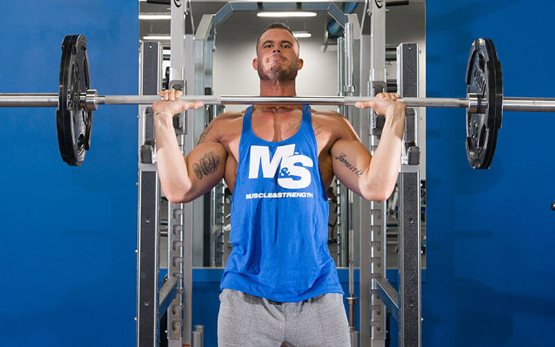 Male Athlete Performing Military Shoulder Presses