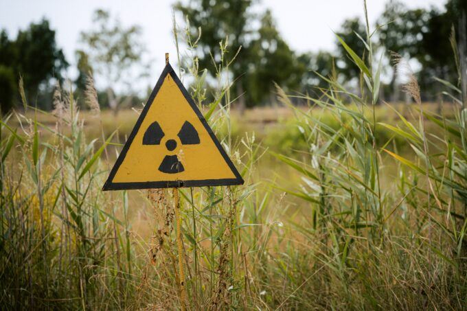 Image of radioactive sign in a field.